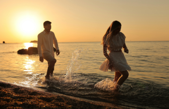 wedded couples near the sea at the sunset