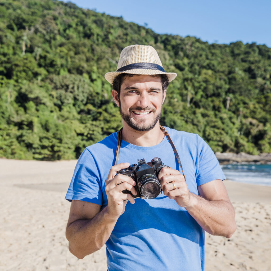 smiling man with camera